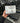 Hand holding a package of Treadmill Belt Lubricant in front of treadmills